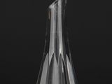 a clear glass vase on a table with a black background