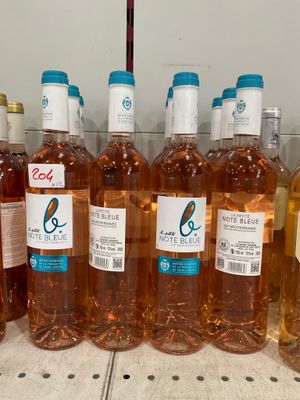 several bottles of wine are lined up on a shelf