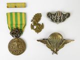 several military medals and badges are displayed on a white surface