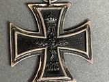 an image of a black and silver cross with a ribbon around it