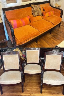 four chairs and a couch in the same room