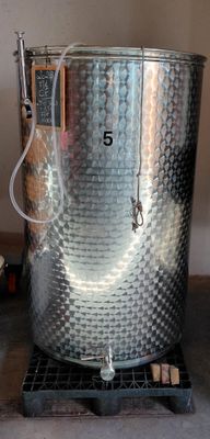 a large metal pot sitting on top of a wooden table