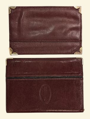 a close up of a brown leather wallet on a white background