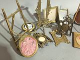a lot of antique picture frames and pictures on the table