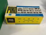 two boxed boxes of vintage model trains sitting on a white surface