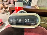 an alarm clock sitting on top of a red chair