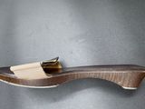 a close up of a wooden object on a gray surface