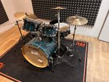 a drum set up in front of a sound booth