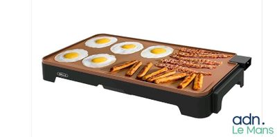 an image of an electric griddle with eggs and pretzels