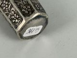a silver object with a tag on it sitting on a table
