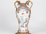 a vase that is sitting on a stand on a white surface