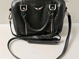 a black purse that is sitting on a table