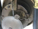 a close up of a clock with a metal wheel