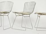 three chairs with a seat made of metal and a seat made of fabric