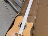 a guitar in a cardboard box sitting on the ground