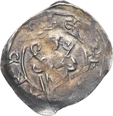 un gros plan d'une pièce d'argent sur laquelle figure l'effigie d'un homme