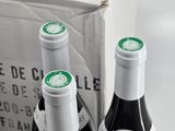 three bottles of wine sitting on a table next to each other