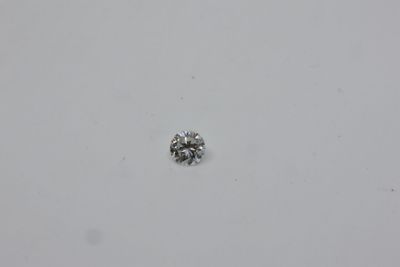 a close up of a single diamond on a white surface