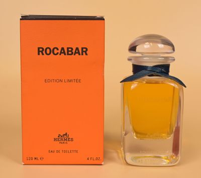 a close up of a bottle of perfume next to a box