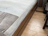 a bed with a wooden headboard and a wooden foot board
