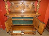 a large wooden cabinet with a door open in a room
