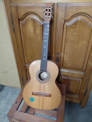 a guitar that is sitting on a wooden stand