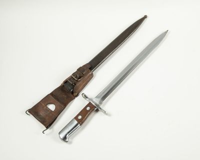 a pair of knifes sitting next to each other on a white surface