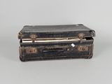 an old suitcase sitting on a table with a white background
