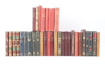 several books are stacked on top of each other on a white surface