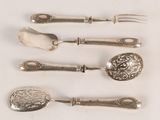 five silver spoons and a fork on a white surface
