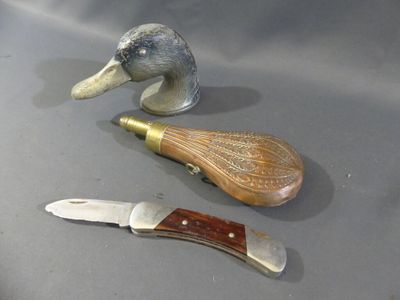 two knives and a duck head on a table