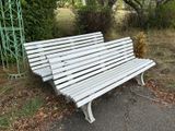 un banc blanc posé au bord de la route