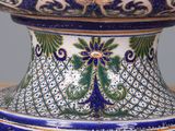 a blue and white vase sitting on top of a table