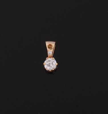 a diamond pendant on a black surface