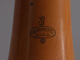 a close up of a wooden vase with a logo on it