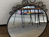 a mirror that is sitting on the floor next to a chair
