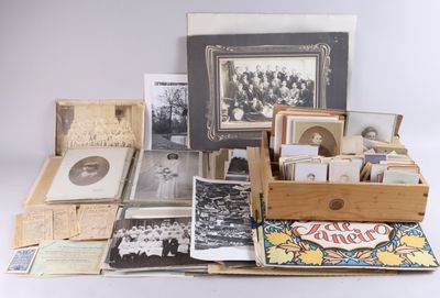 an assortment of old photographs and photographs in a wooden box on a white surface