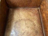 a wooden box that has a brown seat on it