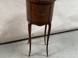 a small wooden table with a drawer on top of it