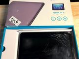 an opened box of a tablet computer sitting on top of a wooden table