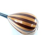 a close up of a wooden instrument on a white surface