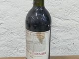 une bouteille de vin rouge posée sur une table en bois