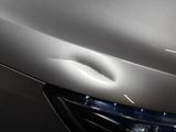 a close up of a car ' s headlight with a hole in it