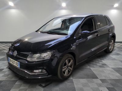 a black volkswagen polo estate parked on a checkered tile floor