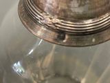 a glass jar with a metal lid sitting on a table