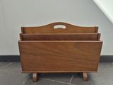 a wooden magazine rack with a magazine holder on it