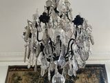 a chandelier hanging from the ceiling in a living room
