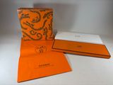 an orange and white box containing a pair of sunglasses and a pair of sunglasses