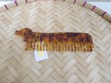 a tortoise shaped comb with a tag on it