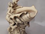 statue of a woman sitting on a shell with a child on it
